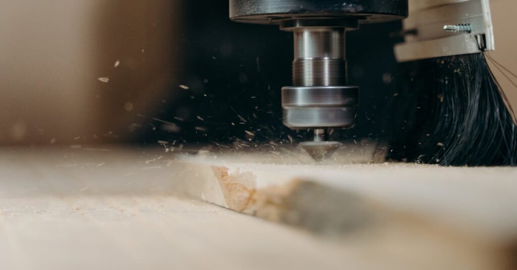 CNC machine in action, precisely cutting a wooden panel with sawdust flying.